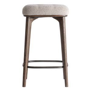 Taburete Zemst de estilo clásico, fabricado en poliéster en color beige, combinado con madera de fresno en color marrón y hierro en color negro.